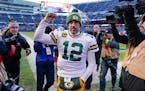 Aaron Rodgers reacts as he walks off the field after Sunday’s game against the Bears