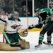 Wild goaltender Marc-Andre Fleury and Jon Merrill defend the goal against Dallas center Tyler Seguin during the first period