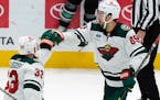 Wild center Frederick Gaudreau is congratulated by teammate Alex Goligoski after Gaudreau scored in the shootout Sunday