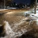 Ryan Merchant signaled to a co-worker a block away as they observed the water gushing downhill on 30th Avenue N. Monday night, Dec. 5, 2022 in Minneap