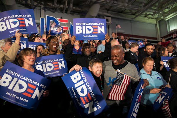 Supporters of former Vice President Joe Biden respond to early returns from the South Carolina Democratic Primary, in Columbia, S.C., Feb. 29, 2020. (