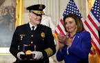 Speaker of the House Nancy Pelosi of Calif., applauds U.S. Capitol Police Chief J. Thomas Manger, during a Congressional Gold Medal ceremony honoring 