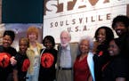 FILE - Stax Records founder Jim Stewart, center, poses for a photo with friends and students of the Stax Music Academy on April 29, 2013 in Memphis, T