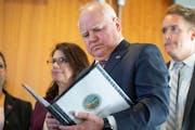 Minnesota Gov. Tim Walz reviews notes before speaking about the state’s budget Tuesday, Dec. 6, 2022, at the Minnesota Department of Revenue in St. 