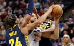 Timberwolves center Rudy Gobert shot between Pacers guard Buddy Hield (24) and center Myles Turner (33) during the second quarter of the Wolves’ 121