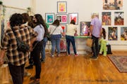 Visitors browse artworks at the Northrup King Building during an open house
