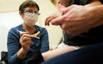 Deborah Sampson, left, a nurse at a University of Washington Medical Center clinic in Seattle, gives a Pfizer COVID-19 vaccine shot to a 20-month-old 