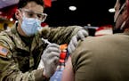 FILE — U.S. Army Private Brandon Ober administers the COVID-19 vaccine to Sgt. Jeff Walston at Ft. Bragg Army Post, N.C., on Feb. 24, 2021. The Hous