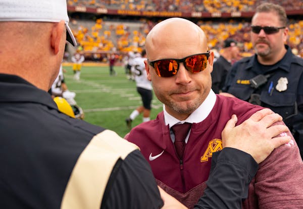 Gophers coach P.J. Fleck shook hands with former Purdue coach Jeff Brohm after their 2022 game at Huntington Bank Stadium.