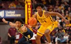 Gophers forward Jaden Henley beat Wolverines guard Kobe Bufkin to a loose ball during the first half Thursday night at Williams Arena.