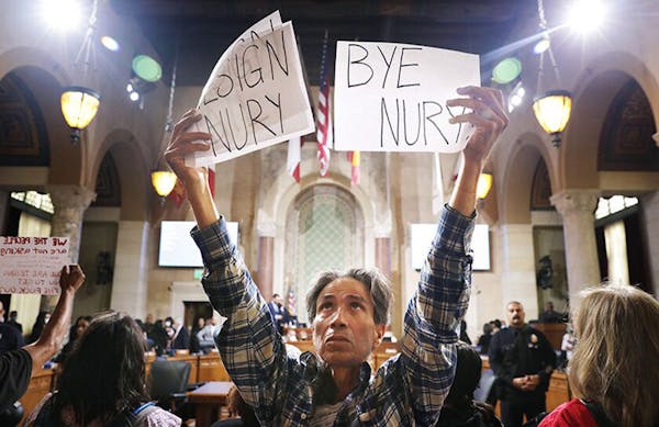 Genaro Leal joins community members in calling for the resignation of Nury Martinez, Kevin de Leon and Gil Cedillo at City Hall Council chambers in do