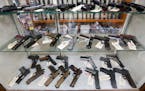 Semiautomatic handguns are displayed at a shop in New Castle, Pa.
