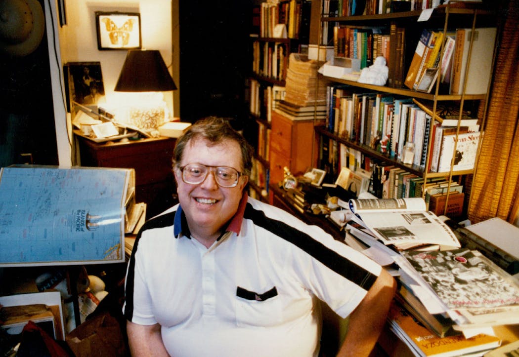 Jean-Nickolaus Tretter, gay historian, amid books and other artifacts in his St Paul home in 1992. He was preparing the History Pavilion display at the Pride festival in Loring Park.