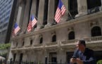 A trader stands outside the New York Stock Exchange, Sept. 23, 2022, in New York.