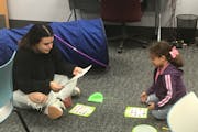 While her mother, Cynthia Gonzalez (not pictured), studied nearby, 6-year-old Mia played a game with NCCC child-care specialist Abi Cardenas, a first-