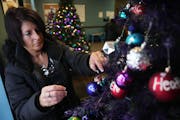 Anne Emerson placed an ornament on a tree honoring those who have had drug-related deaths.
