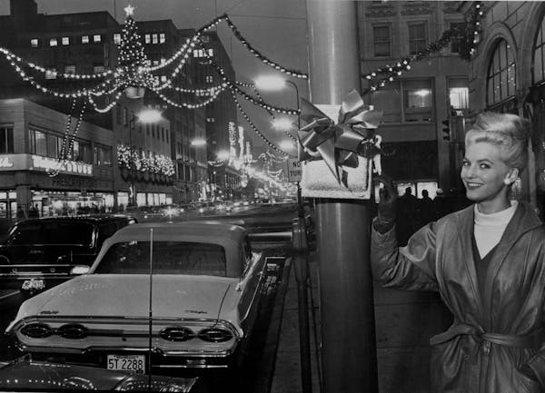 Penny Pilney, Miss Downtown 1963, flipped a switch at 9th Street and Nicollet Avenue to energize holiday lights.