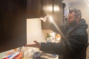 Bryce Ekeren explained how his cabinets have been partially falling off the wall for six months at Parkvue Flats in Burnsville. Ekeren placed a repair