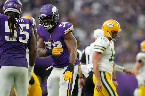 Vikings linebacker Danielle Hunter (99) celebrated with fellow linebacker Za’Darius Smith (55) after sacking Packers quarterback Aaron Rodgers when 