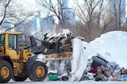 Minneapolis crews cleared a homeless camp near the Quarry shopping center in northeast Minneapolis on Friday.