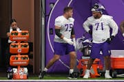 Vikings right tackle Brian O’Neill (75) talked with left tackle Christian Darrisaw (71) during a practice last season.