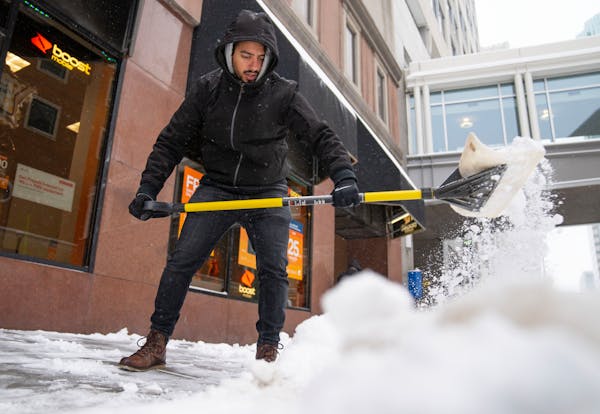 Harris Ahmad shoveled snow during a winter storm this week on 9th Street S. in Minneapolis. The storm dropped 15 inches of snow on the Twin Cities are