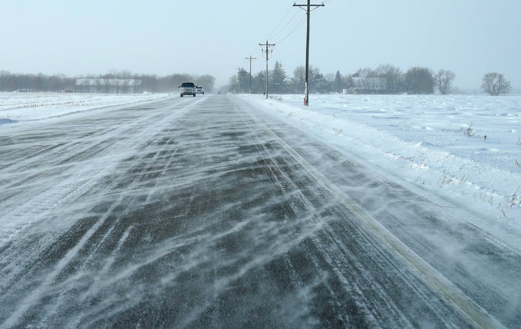 High winds blew snow across a rural Dakota County highway in December 2022. 
