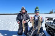 Sarah Strommen, DNR commissioner, with her son, Will, lake trout fishing near the BWCA in March 2022.