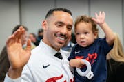 Minnesota Twins shortstop Carlos Correa and his son, Kylo, 1, wave to the cameras after a press conference on Wednesday.