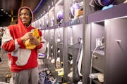 Minnesota Vikings wide receiver Justin Jefferson (18) gives out his cleats to other players in the locker room at the TCO Performance Center in Eagan,