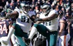 Fletcher Cox, left, and Javon Hargrave helped the Eagles lead the NFL in sacks with 70, tied for the third-most ever in the regular season.