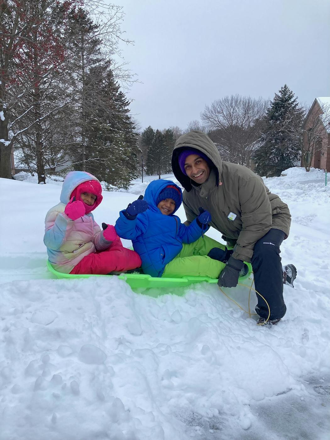 Dr. Krish Subrahmanian, a pediatrician at Hennepin Healthcare, modeled proper winter layering while sledding with his kids, Leela and Kiaan.