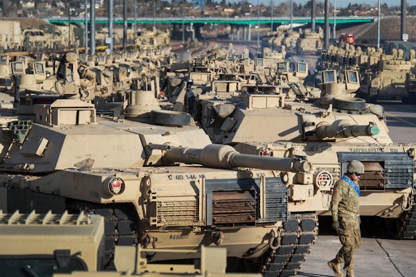 FILE - A soldier walks past a line of M1 Abrams tanks, Nov. 29, 2016, at Fort Carson in Colorado Springs, Colo. In what would be a reversal, the Biden