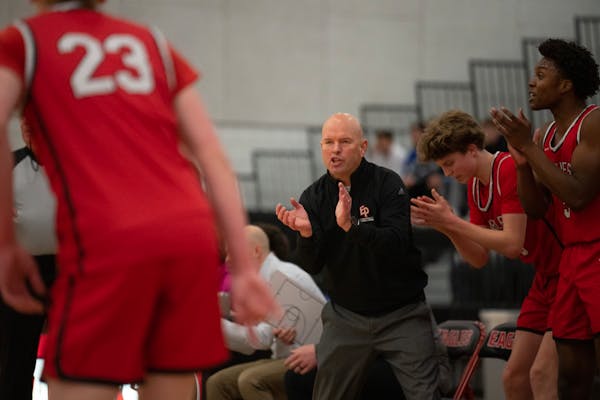 Eden Prairie coach David Flom talked to his team during a first-half timeout. Flom coached his first game Tuesday since he was reinstated after being 