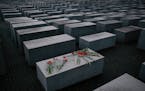 Flowers lay on a concrete slab of the Holocaust Memorial in Berlin Jan. 2015.