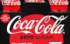 A close-up of a six-pack of bottled Coca-Cola Zero Sugar. 