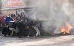 Palestinians clash with Israeli forces following an army raid in the West Bank city of Jenin, Thursday, Jan. 26, 2023. Israeli forces killed at least 