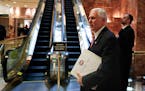 Then-Vice President-elect Mike Pence carries a briefing binder at Trump Tower in November 2016. The discovery of classified documents at Pence’s hom