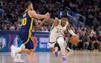 Ja Morant of the Grizzlies drove around Golden State’s Steph Curry on Wednesday night. Memphis plays the Wolves at Target Center on Friday night.