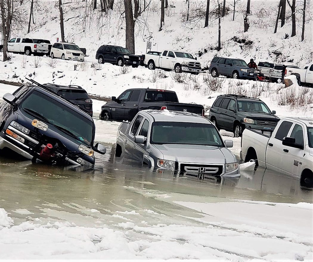 Some of about 15 vehicles parked on the Mississippi River by anglers near Frontenac, Minn., sunk Saturday morning Jan. 21. Some could be driven off, while others had to be towed.