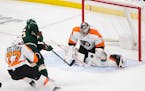 Trailed by Philadelphia Flyers defenseman Tony DeAngelo (77)Minnesota Wild right wing Mats Zuccarello (36) lifted the puck over the glove of Flyers go