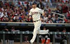 Minnesota Twins first baseman Joe Mauer (7) scored after Minnesota Twins right fielder Max Kepler (26) was walked with the bases loaded in the first i