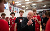 David Flom talked to his Eden Prairie team during a timeout Tuesday in his first game back after reinstatement.
