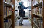 Kathy Defor looked through books after hours at Elko New Market Library.