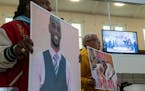 Activists hold signs showing Tyre Nichols in advance of the release of video footage of the violent police encounter in Memphis that led to Nichols’