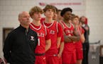 Eden Prairie boys basketball coach David Flom stood with his players for the national anthem before their game against Wayzata at Eden Prairie High Sc