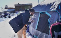 A housing access coordinator for the social services organization the Housing Guy talked to a resident of a homeless encampment in south Minneapolis o