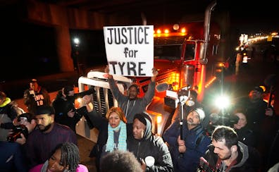 Protesters marched down a street Friday in Memphis, Tenn., as authorities released police video depicting five Memphis officers beating Tyre Nichols.