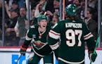Minnesota Wild left wing Matt Boldy, left, celebrates with left wing Kirill Kaprizov (97) after scoring a goal during the third period of an NHL hocke