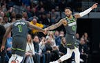 Anthony Edwards and D’Angelo Russell of the Wolves reset the team’s defense during a victory Saturday over Sacramento.